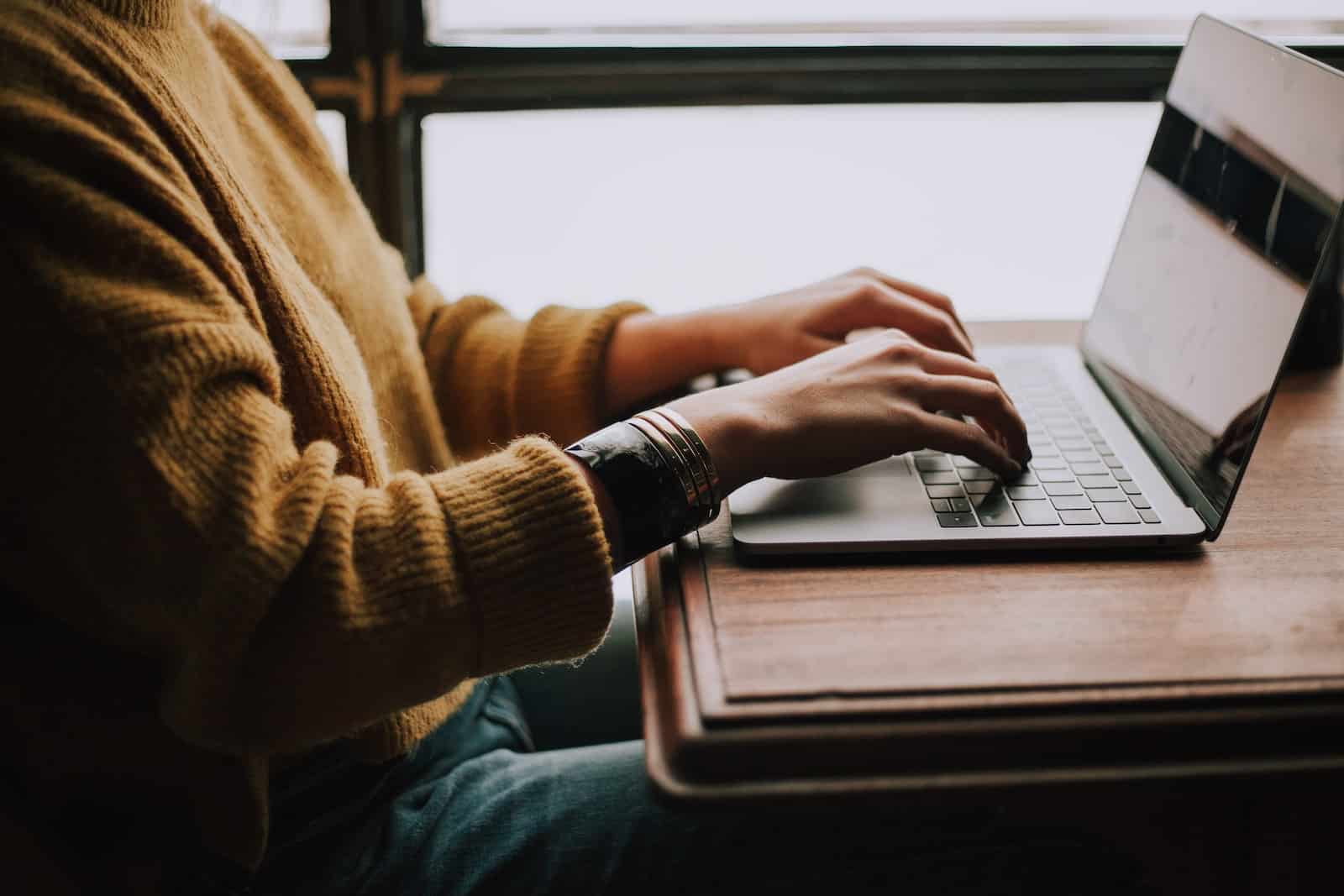 person sitting front of laptop